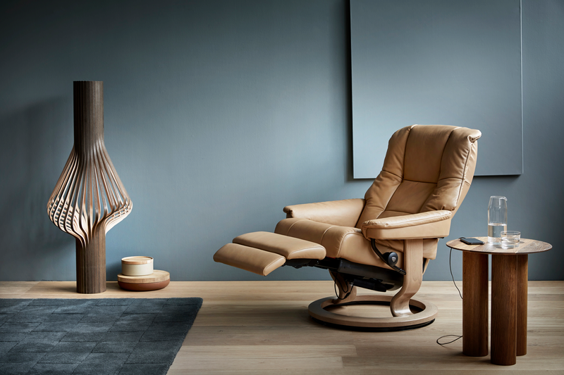 The Stressless Mayfair is one of the most iconic recliners in the Stressless collection, loved for its refined style, plush cushioning, and superb ergonomic support. With its gently curved lines, softly padded armrests, and luxurious feel, the Mayfair recliner blends classic design with modern comfort.
Beneath its elegant exterior, the Mayfair features the patented Plus™ and Glide™ systems, which automatically adjust to your body’s movement providing continuous support in all the right places whether you're sitting upright or reclining.
Available in Small, Medium, and Large sizes, and fully customisable with a choice of leathers, fabrics, and wood finishes, the Mayfair also comes with a matching footstool available and a variety of base styles including Classic, Signature, and Cross. Add even more luxury with Stressless Power - their innovative and motorised comfort function.