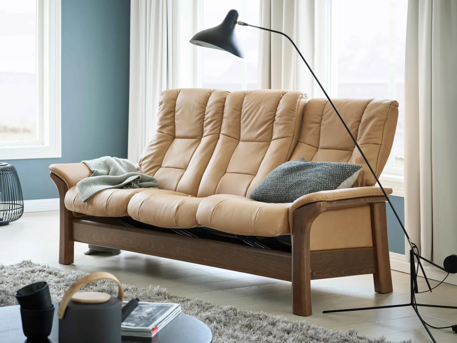 Timeless elegance meets modern functions with this beautifully cushioned, high-back sofa.

The Stressless Windsor and Stressless Buckingham are sofas that never go out of style, with their combination of soft cushions and beautiful wood.

Featuring the same design, you can choose from Stressless Windsor which is based on a medium sized seat or Stressless Buckingham which features a wider seat. They also have the Plus™-system, which means that the sofa follows your movements and provides good support in all sitting positions.

Available as a 3 Seater, 2 Seater or Chair with a wide choice of premium leathers, fabrics and wood finishes, the Windsor brings pure, classic comfort to any living space.
